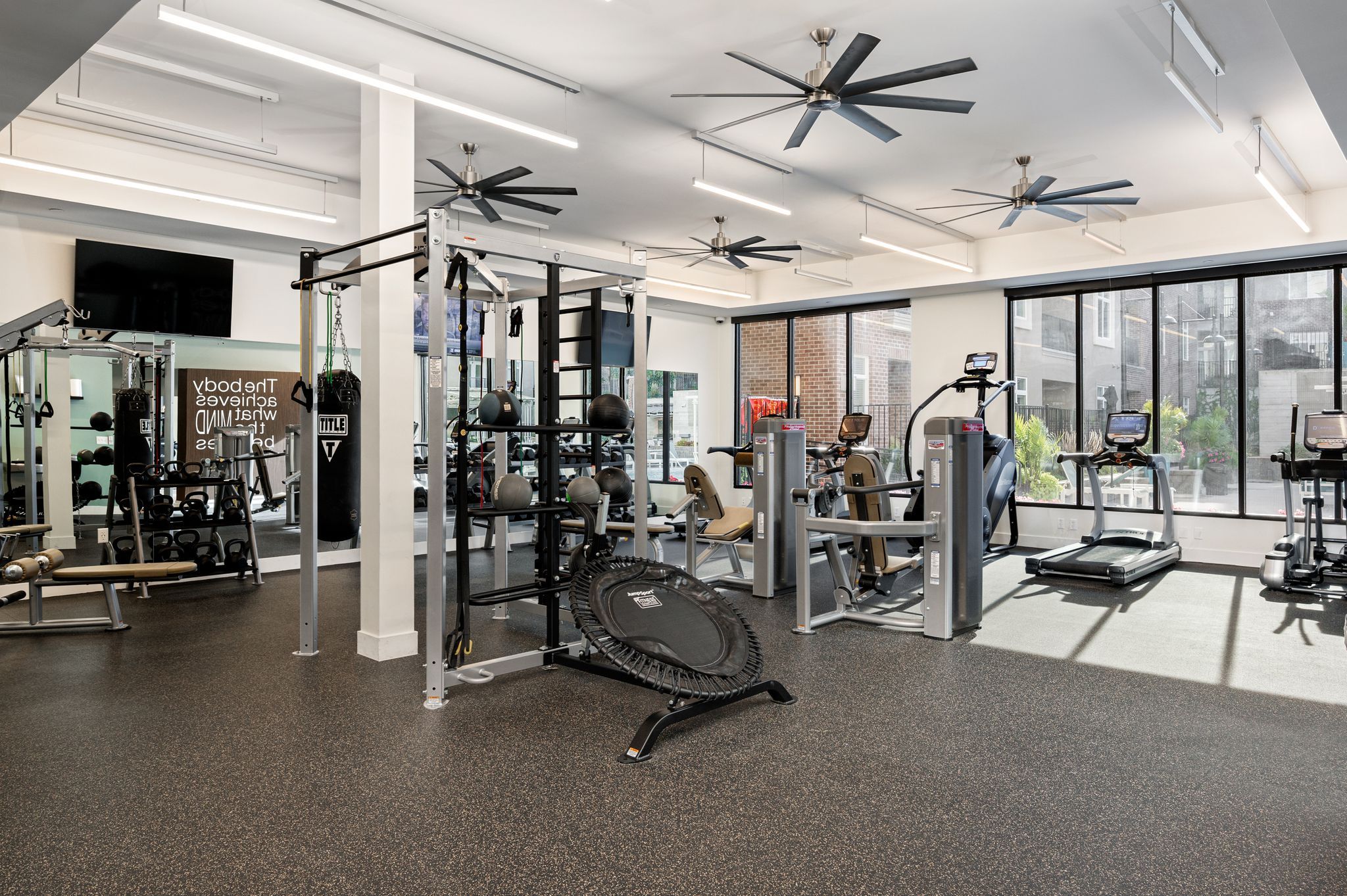 Domain City Center Exercise equipment and a ceiling fan in a gym room.